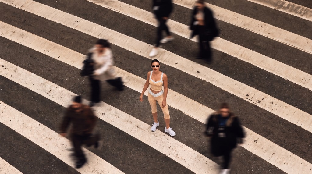 Model in the Florence Active butter gingham set on a city crosswalk, aerial view